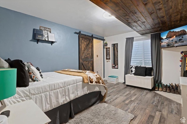 6533 W Elena St S, West Valley City, UT 84128 - bedroom with a barn door, hardwood / wood-style floors, and wood ceiling
