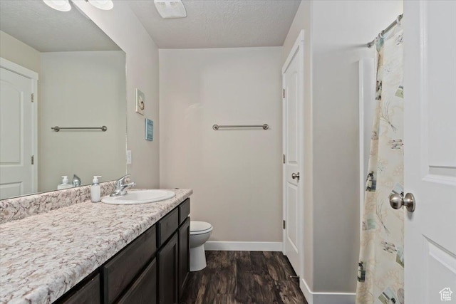 6533 W Elena St S, West Valley City, UT 84128 - bathroom with wood finished floors, vanity, and a textured ceiling