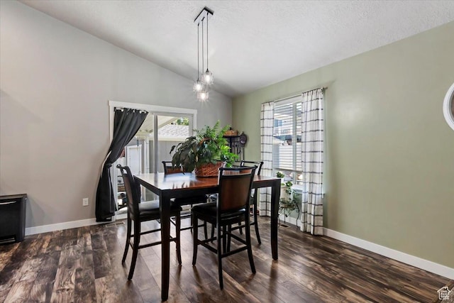 6533 W Elena St S, West Valley City, UT 84128 - dining space featuring vaulted ceiling, dark wood-style flooring, and a textured ceiling