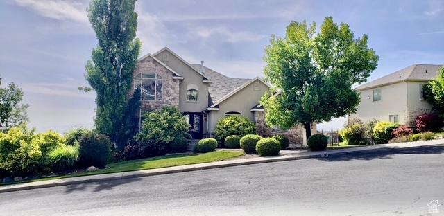 9061 N Canyon Dr, Cedar Hills, UT 84062 - obstructed view of property with stone siding and stucco siding