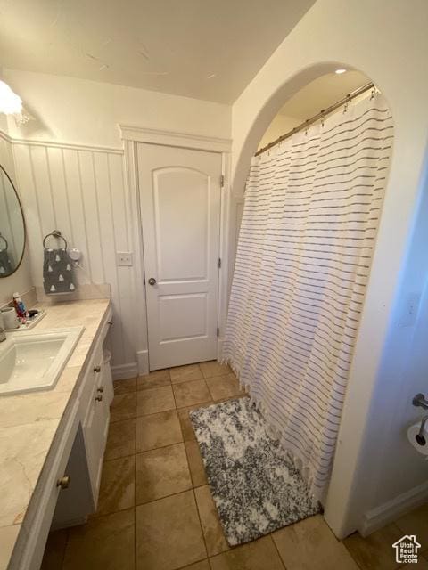9061 N Canyon Dr, Cedar Hills, UT 84062 - full bath featuring vanity, tile patterned floors, and wainscoting