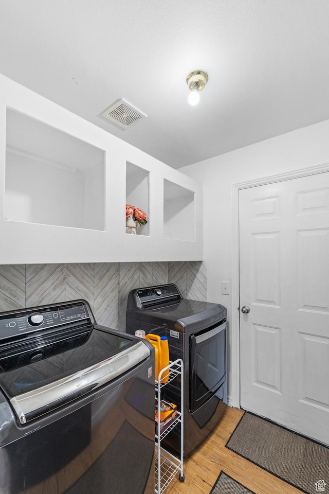 25 E 1860 N, Tooele, UT 84074 - laundry area featuring washing machine and clothes dryer and light wood-type flooring