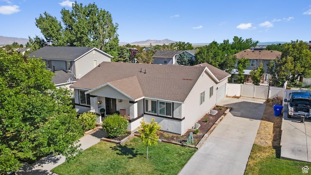 25 E 1860 N, Tooele, UT 84074 - view of front of home featuring concrete driveway, roof with shingles, a residential view, and a mountain view