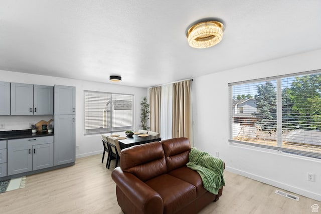 25 E 1860 N, Tooele, UT 84074 - living area featuring light wood-style floors and baseboards