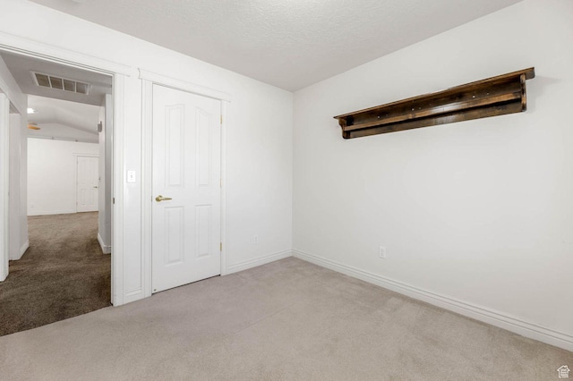 2474 N Dorchester Ave, Harrisville, UT 84414 - unfurnished bedroom featuring carpet, vaulted ceiling, and a textured ceiling