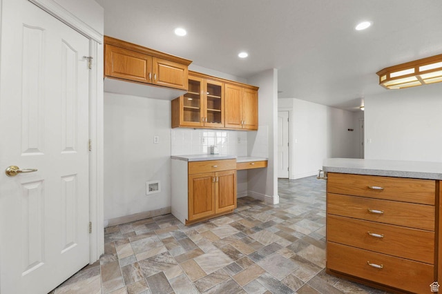 2474 N Dorchester Ave, Harrisville, UT 84414 - kitchen with light countertops, brown cabinetry, light stone finish flooring, glass insert cabinets, and recessed lighting