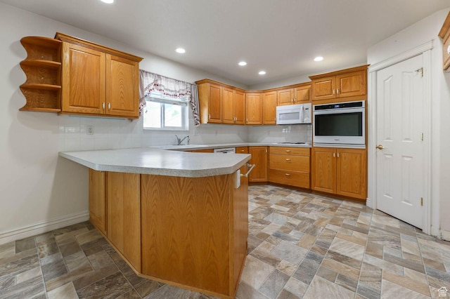 2474 N Dorchester Ave, Harrisville, UT 84414 - kitchen with white appliances, a peninsula, light stone finish floors, decorative backsplash, and light countertops