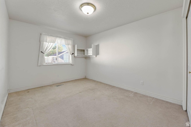 2474 N Dorchester Ave, Harrisville, UT 84414 - spare room featuring light carpet and a textured ceiling