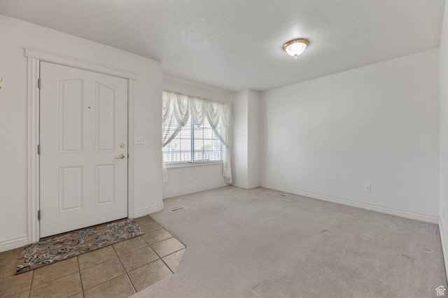 2474 N Dorchester Ave, Harrisville, UT 84414 - carpeted entryway featuring tile patterned floors and a textured ceiling