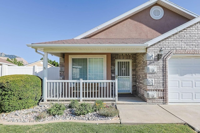 2474 N Dorchester Ave, Harrisville, UT 84414 - property entrance with covered porch, a garage, and roof with shingles