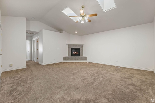 2474 N Dorchester Ave, Harrisville, UT 84414 - unfurnished living room with lofted ceiling, carpet floors, a ceiling fan, a fireplace, and a skylight