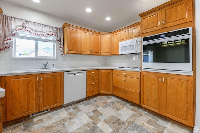 2474 N Dorchester Ave, Harrisville, UT 84414 - kitchen featuring white appliances, stone finish flooring, recessed lighting, light countertops, and decorative backsplash