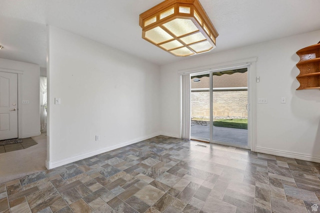 2474 N Dorchester Ave, Harrisville, UT 84414 - unfurnished dining area featuring stone finish floors and baseboards