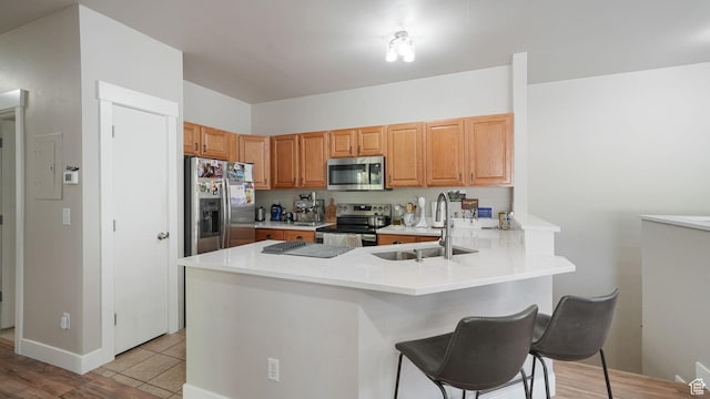 8457 S Ivy Springs Ln W, West Jordan, UT 84081 - kitchen featuring stainless steel appliances, a peninsula, a breakfast bar, light countertops, and electric panel