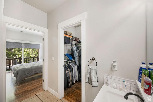 8457 S Ivy Springs Ln W, West Jordan, UT 84081 - ensuite bathroom with a walk in closet and wood finished floors