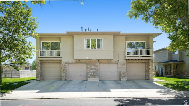 8457 S Ivy Springs Ln W, West Jordan, UT 84081 - view of front of home featuring a garage, stone siding, stucco siding, and driveway
