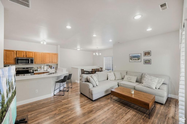 8457 S Ivy Springs Ln W, West Jordan, UT 84081 - living room with wood finished floors, a chandelier, and recessed lighting