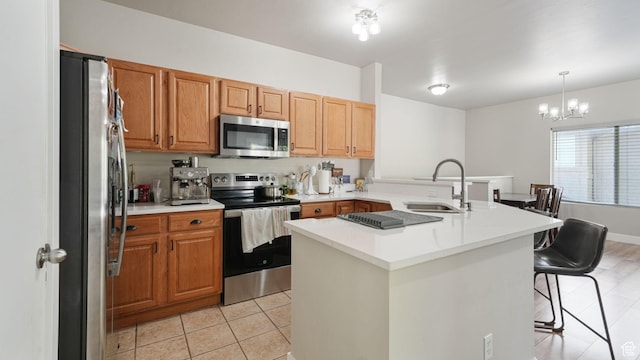 8457 S Ivy Springs Ln W, West Jordan, UT 84081 - kitchen with stainless steel appliances, a breakfast bar, light tile patterned floors, light countertops, and a chandelier