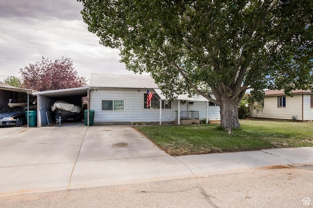 70 N 1100 W, Vernal, UT 84078 - view of front of home featuring an attached carport, concrete driveway, and a front lawn