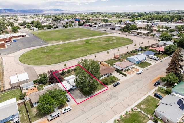 70 N 1100 W, Vernal, UT 84078 - aerial view of residential area with property boundaries highlighted and a mountainous background