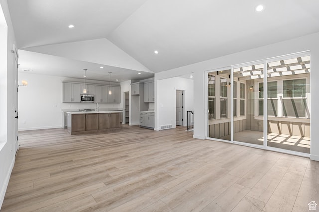 11184 S Easy Bee Rd Unit 265, South Jordan, UT 84009 - unfurnished living room with light wood finished floors, vaulted ceiling, and recessed lighting