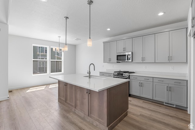 11184 S Easy Bee Rd Unit 265, South Jordan, UT 84009 - kitchen featuring appliances with stainless steel finishes, gray cabinetry, a chandelier, light countertops, and recessed lighting