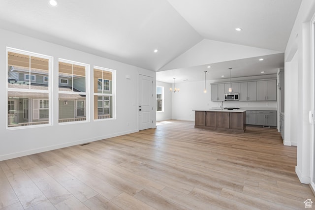 11184 S Easy Bee Rd Unit 265, South Jordan, UT 84009 - kitchen featuring open floor plan, stainless steel microwave, gray cabinetry, an island with sink, and recessed lighting