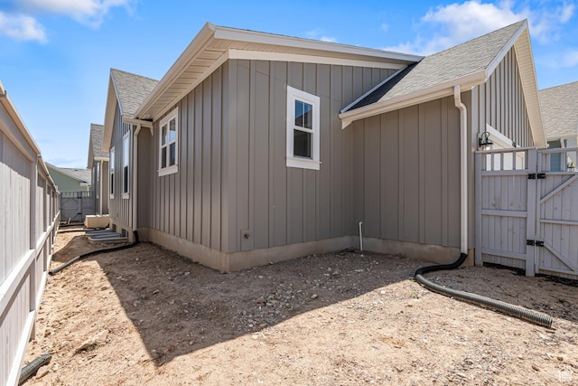 11184 S Easy Bee Rd Unit 265, South Jordan, UT 84009 - view of side of home featuring roof with shingles, a gate, and board and batten siding