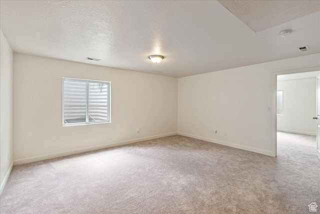 5239 W Mellow Way S, Jordan, UT 84009 - empty room featuring light carpet, a textured ceiling, healthy amount of natural light, and a smoke detector