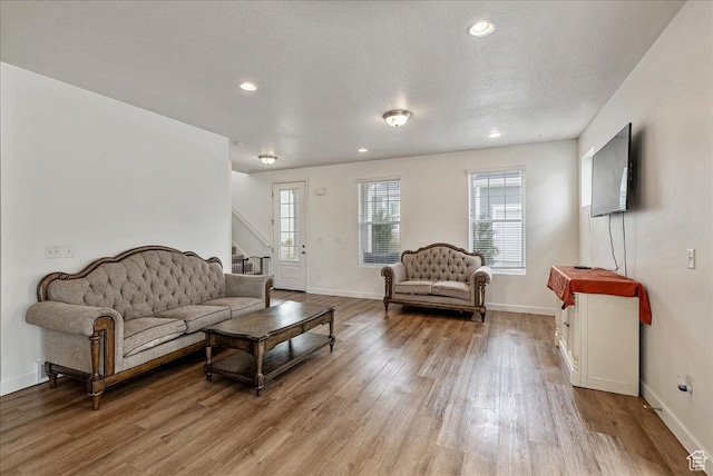 5239 W Mellow Way S, Jordan, UT 84009 - living room with light wood-type flooring, stairway, recessed lighting, and a textured ceiling