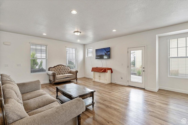 5239 W Mellow Way S, Jordan, UT 84009 - living area with a textured ceiling, light wood-style flooring, and recessed lighting