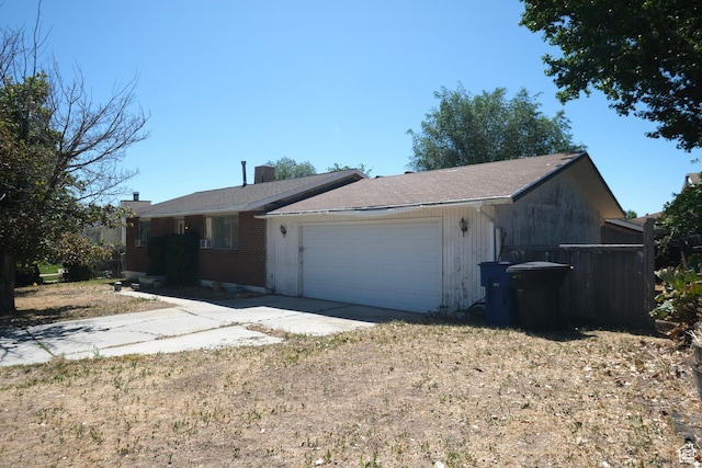 4217 W Twilight Dr S, Salt Lake City, UT 84118 - view of front of house with driveway, an attached garage, and brick siding