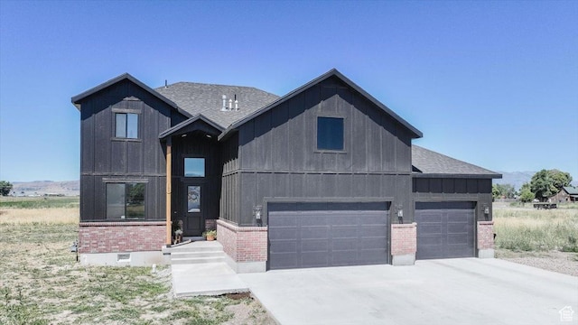 165 N 300 W, Preston, ID 83263 - modern farmhouse featuring brick siding, board and batten siding, concrete driveway, roof with shingles, and an attached garage