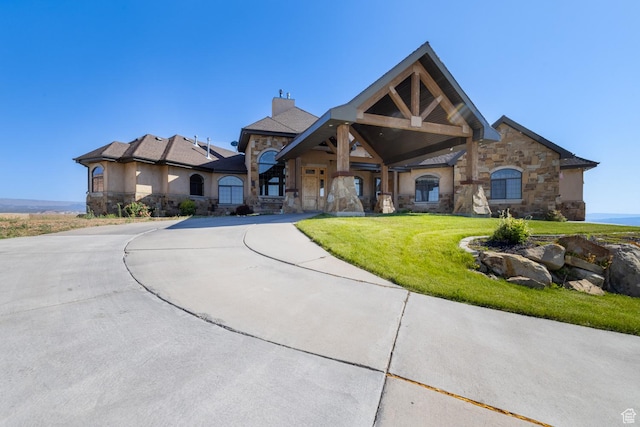 2849 W 1800 S, Vernal, UT 84078 - view of front facade featuring stone siding, a chimney, stucco siding, and a front lawn