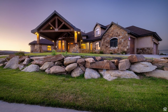2849 W 1800 S, Vernal, UT 84078 - view of front of property with stone siding, an attached garage, stucco siding, and a front lawn