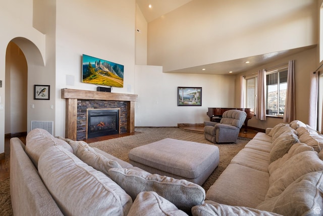 2849 W 1800 S, Vernal, UT 84078 - living area with arched walkways, a towering ceiling, a stone fireplace, recessed lighting, and wood finished floors