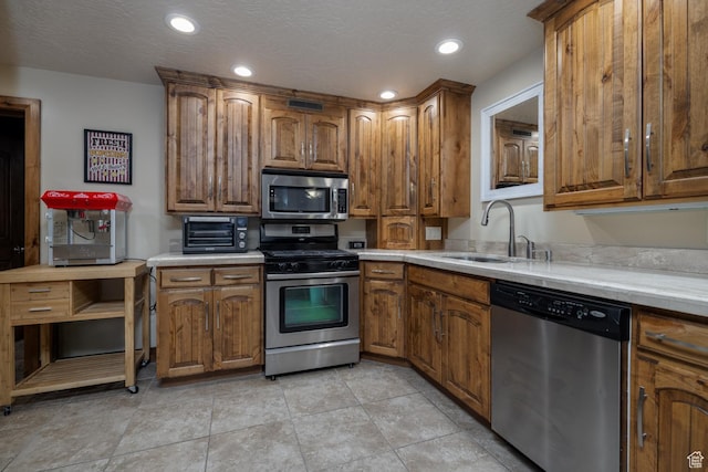 2849 W 1800 S, Vernal, UT 84078 - kitchen featuring stainless steel appliances, brown cabinets, light countertops, and recessed lighting