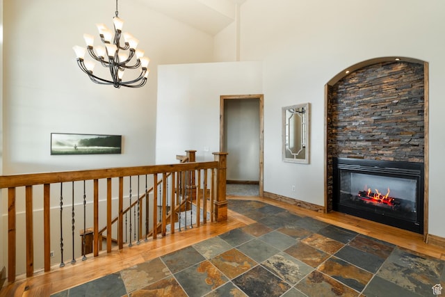 2849 W 1800 S, Vernal, UT 84078 - hallway featuring stone tile floors, an upstairs landing, a chandelier, and a high ceiling