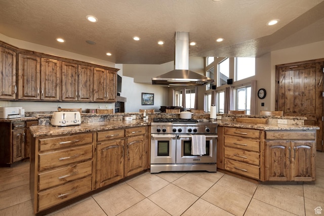 2849 W 1800 S, Vernal, UT 84078 - kitchen featuring range with two ovens, exhaust hood, recessed lighting, a peninsula, and light stone counters