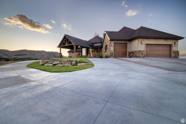 2849 W 1800 S, Vernal, UT 84078 - view of front of home featuring stone siding, a garage, and concrete driveway