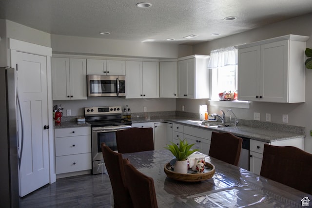 122 N 1325 W, Springville, UT 84663 - kitchen featuring stainless steel appliances, a textured ceiling, white cabinetry, recessed lighting, and dark wood-style floors