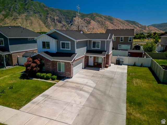 122 N 1325 W, Springville, UT 84663 - view of front of home featuring brick siding, a garage, a mountain view, driveway, and board and batten siding