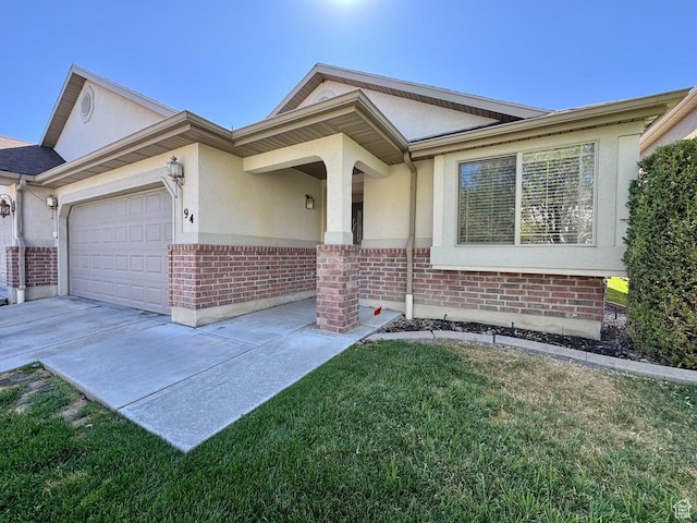 94 Hillsborough Dr, Pleasant View, UT 84414 - ranch-style home featuring brick siding, a garage, stucco siding, and concrete driveway