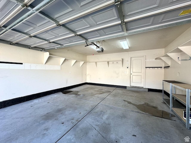 94 Hillsborough Dr, Pleasant View, UT 84414 - garage featuring baseboards and a garage door opener
