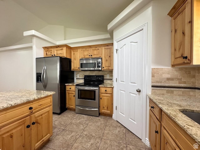 94 Hillsborough Dr, Pleasant View, UT 84414 - kitchen with stainless steel appliances, vaulted ceiling, decorative backsplash, light stone counters, and light tile patterned floors