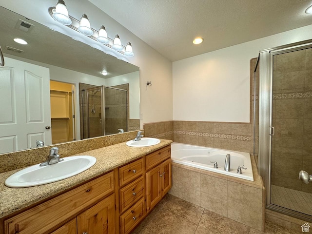 94 Hillsborough Dr, Pleasant View, UT 84414 - bathroom featuring a shower stall, a garden tub, double vanity, and tile patterned flooring