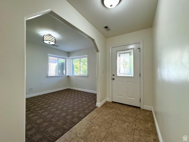 94 Hillsborough Dr, Pleasant View, UT 84414 - carpeted foyer with arched walkways and tile patterned floors