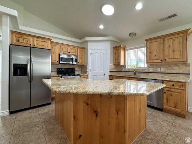 94 Hillsborough Dr, Pleasant View, UT 84414 - kitchen with appliances with stainless steel finishes, tasteful backsplash, a kitchen island, light stone countertops, and vaulted ceiling