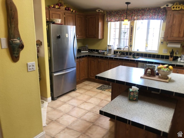 15700 N 7100 E, Spring City, UT 84662 - kitchen with freestanding refrigerator, brown cabinets, and decorative light fixtures