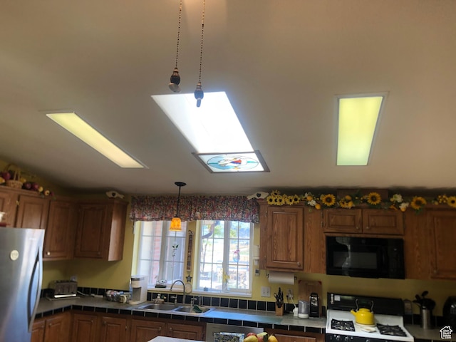 15700 N 7100 E, Spring City, UT 84662 - kitchen featuring black microwave, freestanding refrigerator, range, tile counters, and hanging light fixtures